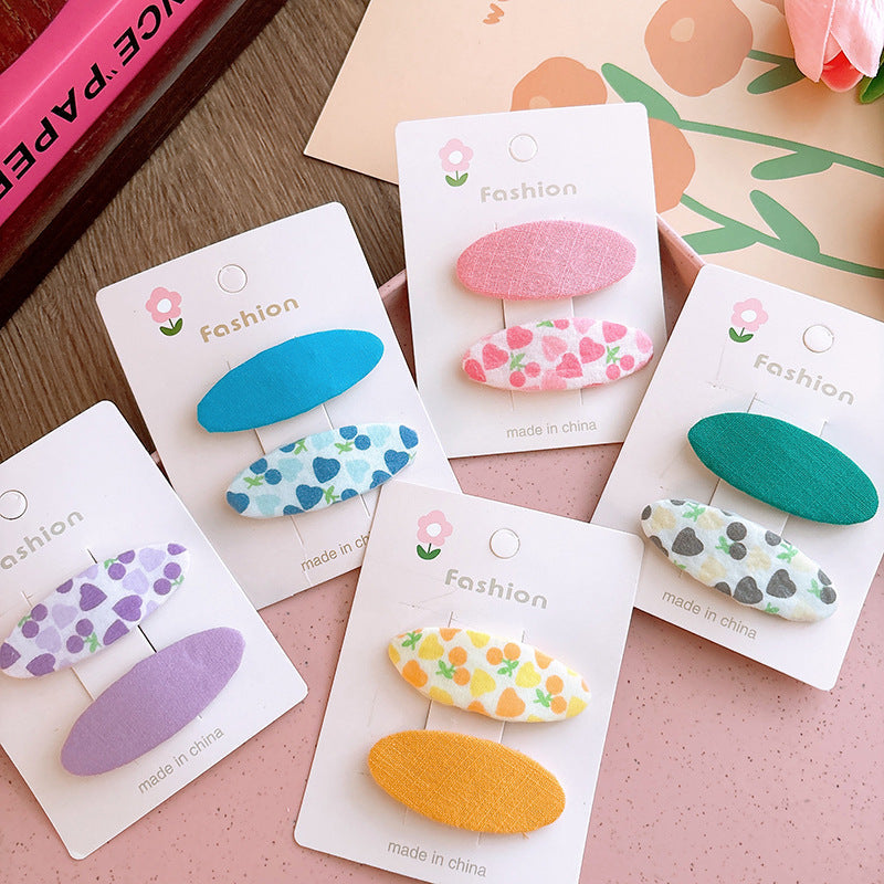 Of 2 Candy-Colored Oval Cloth Hair Clips