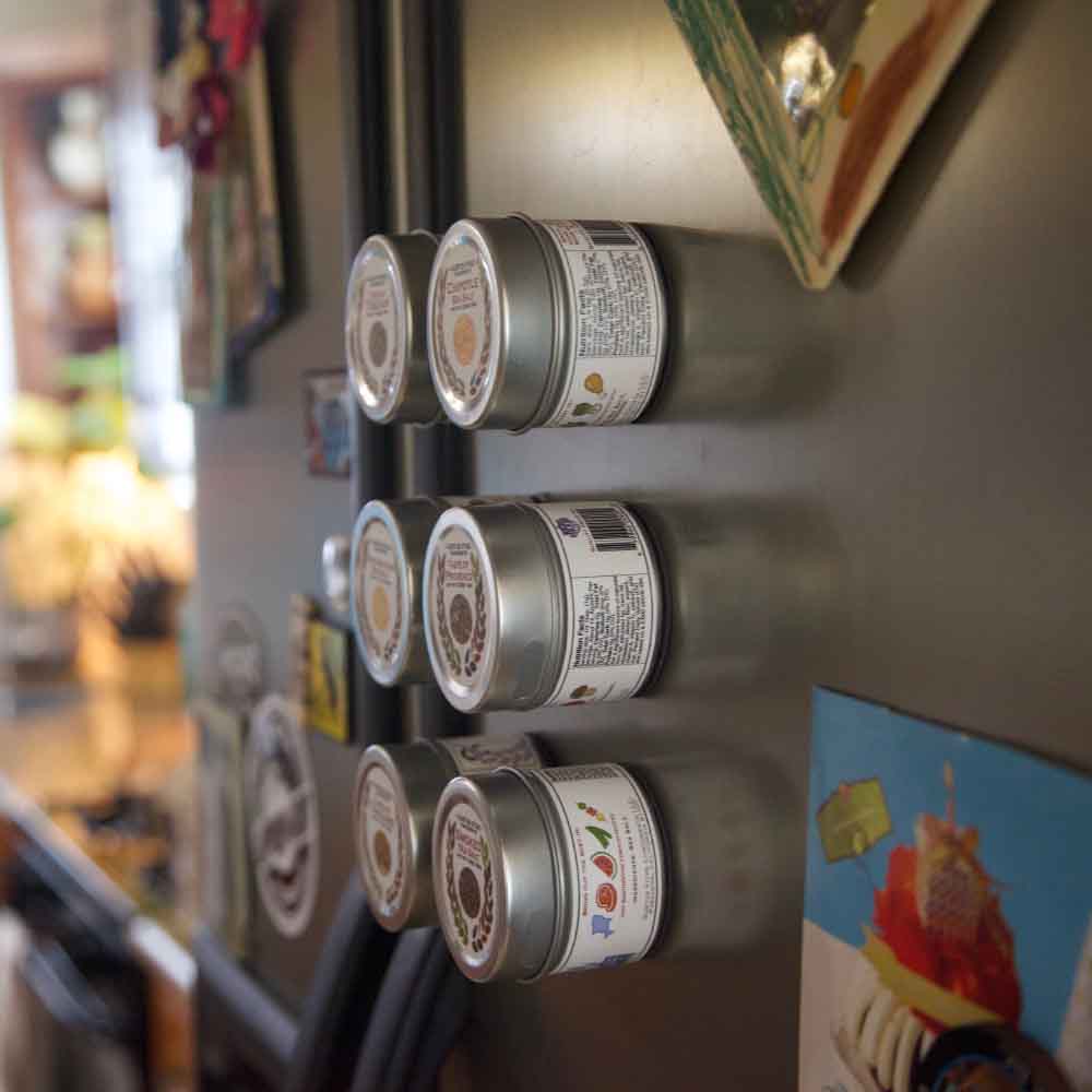 Magnetic tin designs of Gustus Vitae Seasoning Set showcasing unique spices